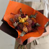 A compact, rustic bunch of dried blooms in warm autumn tones-this dried