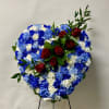 This Standing Solid Heart Includes White, Light Blue and Royal Blue Carnations