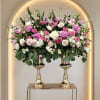 Soft blooms rising from a beautiful set of gold pedestal vases in
