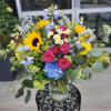Large mixed bouquet with sunflowers, hot pink roses, blue hydrangea, daisies in