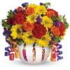 Colorful mixed bouquet in a white vase with curling ribbons