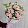 Bouquet of pink roses with white baby's breath in white wrap