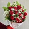 Bouquet of red roses with white baby's breath in white wrapping