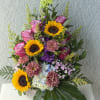 Sunflower brightness meets garden-fresh romance in this cheerful summer bouquet-perfect as a