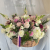 Basket arrangement of pink and white flowers with ribbon accents