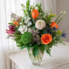Bright, joyful orange roses take center stage in this birthday bouquet and