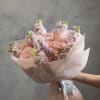 A graceful bouquet of blush pink roses and soft pink stock flowers