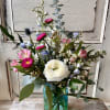 A small colored glass vase or jar holds a just right petite