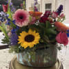 Sunflowers and pink gerbera daisies steal the show in this cheerful mixed