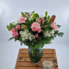 Introducing a stunning flower arrangement that exudes elegance and charm. This exquisite