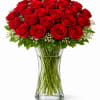2 Dozen fresh red roses in a glass vase.