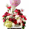 A cheerful woven basket overflowing with pink, red and white blooms-this flower