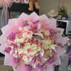 Blush pink and ivory roses mingle with open pink-and-white lilies in this
