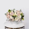 The Blush Bliss arrangement pairs soft blush roses, white hydrangeas, lisianthus, and