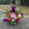 Mixed bouquet in a glass vase with purple, pink, orange, and white flowers