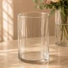 Clear cylindrical glass vase on a tabletop
