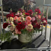 Deep, romantic red roses take center stage in this generous flower arrangement