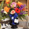 Bright, layered color takes center stage in this large sympathy basket-style arrangement-though