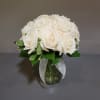 White rose bouquet in a glass vase with a sheer ribbon