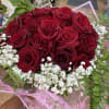 A bouquet of 35 red roses wrapped in patterned Korean paper and