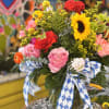 A bold, cheerful mixed-color flower arrangement that instantly reads as celebration -