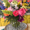 Bright pink roses and lavender blooms take center stage in this cheerful