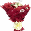 A dense cluster of red and white roses wrapped in layered burgundy