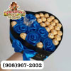 A heart-shaped gift box brimming with vivid blue silk roses and gleaming