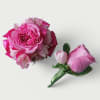 Pink rose and mixed flower bouquet with matching pink rose boutonniere on white background