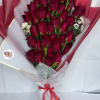 Deep red roses arranged in a rounded, hand-tied bouquet create an immediate