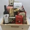 Gift basket with wine and assorted chocolates in a wooden crate