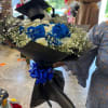 Bright, vivid blue roses set against crisp white roses and airy baby's