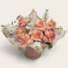 Soft peach roses meet fragrant white stock flowers in this elegant garden-inspired