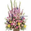 Fresh flowers such as pink roses, lilies, gladioli and larkspur stems artfully