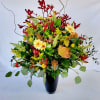 A beautiful red, orange &amp; yellow arrangement with a variety of flowers