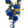 Vivid blue roses rise above dark green foliage in a tall clear
