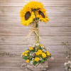 Sunflower arrangement in a rustic wooden box with yellow roses and daisies
