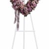 A heart-shaped standing wreath crafted in soft pinks, lavenders and clean whites-designed