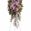 A tall standing sympathy spray that reads with quiet elegance - the