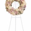 Soft blush roses, creamy chrysanthemums, and delicate spray roses form a serene