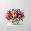 This arrangement is a new design using peaches, oranges and purples. The
