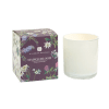 White glass jar candle beside a floral-printed Maison Bloom box