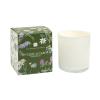 White glass candle next to a green botanical-printed box labeled Botanical Verde.