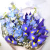 Bouquet of blue and purple flowers wrapped in clear paper