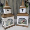 Two wooden memorial lanterns with cross cutouts and printed bird designs