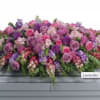 Like a heartfelt embrace, this beautiful casket spray delivers comfort and love