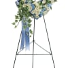 A large heart-shaped wreath crafted in a cool white and blue palette
