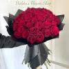 A lush, full cluster of deep red roses-fifty heads arranged into a