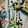 Cross 
White fillers flowers
Roses
Lillie&rsquo;s
Greenery