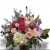Soft, romantic and effortlessly cheerful, this Summer Breeze flower arrangement is a